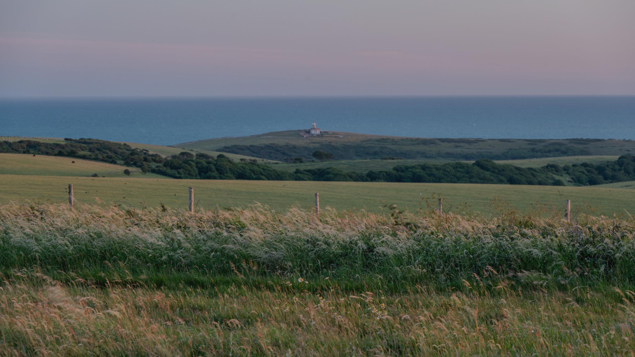 The South Downs running down to the sea at Belle Tout, at dusk